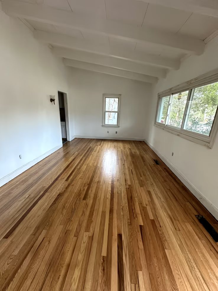 Hardwood floor with a renewed finish across a full room